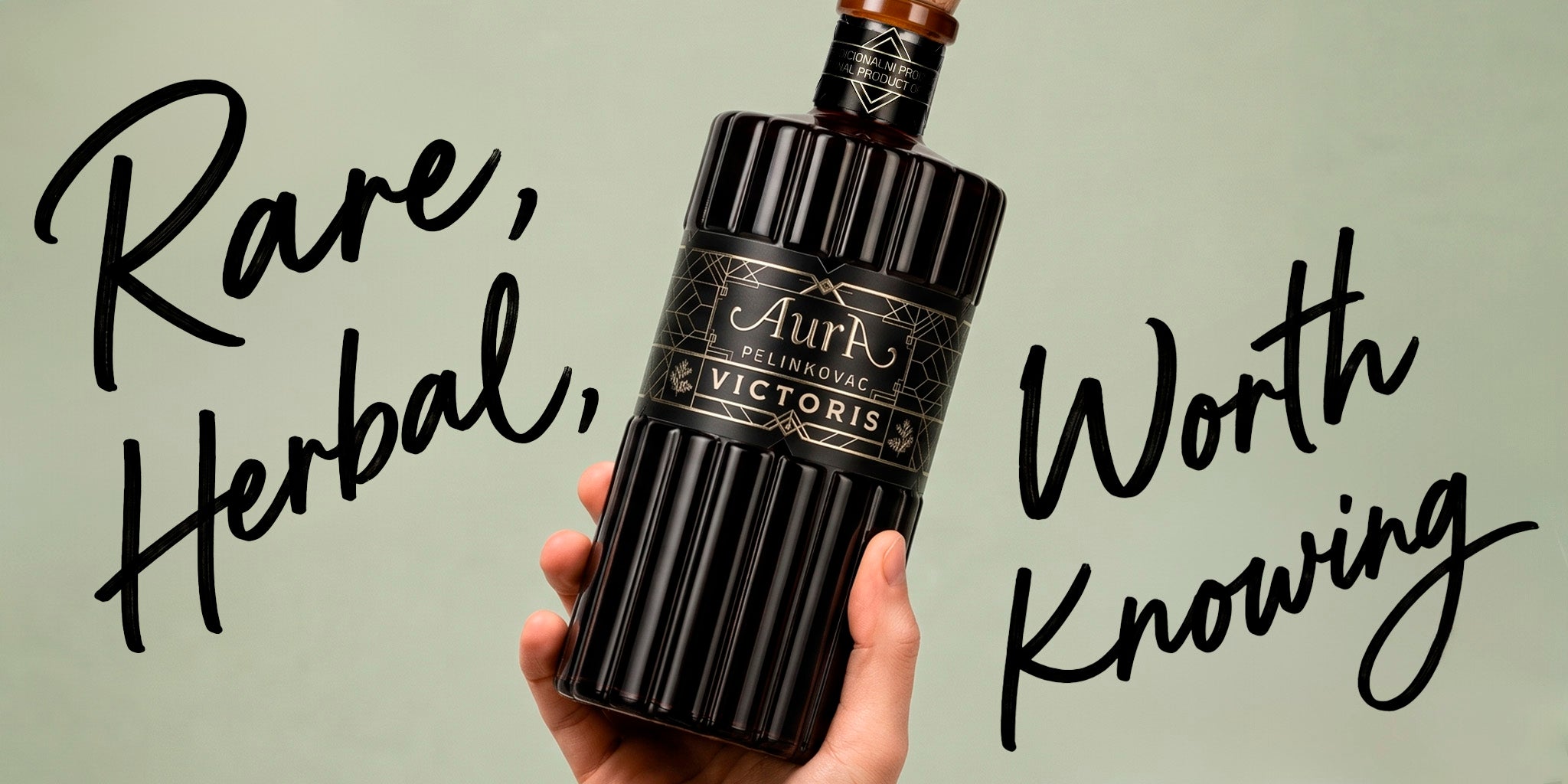 Aura Victoris Pelinkovac herbal digestif bottle held against a minimal background with bold text, styled as a rare European bitter for a standout bar shelf.