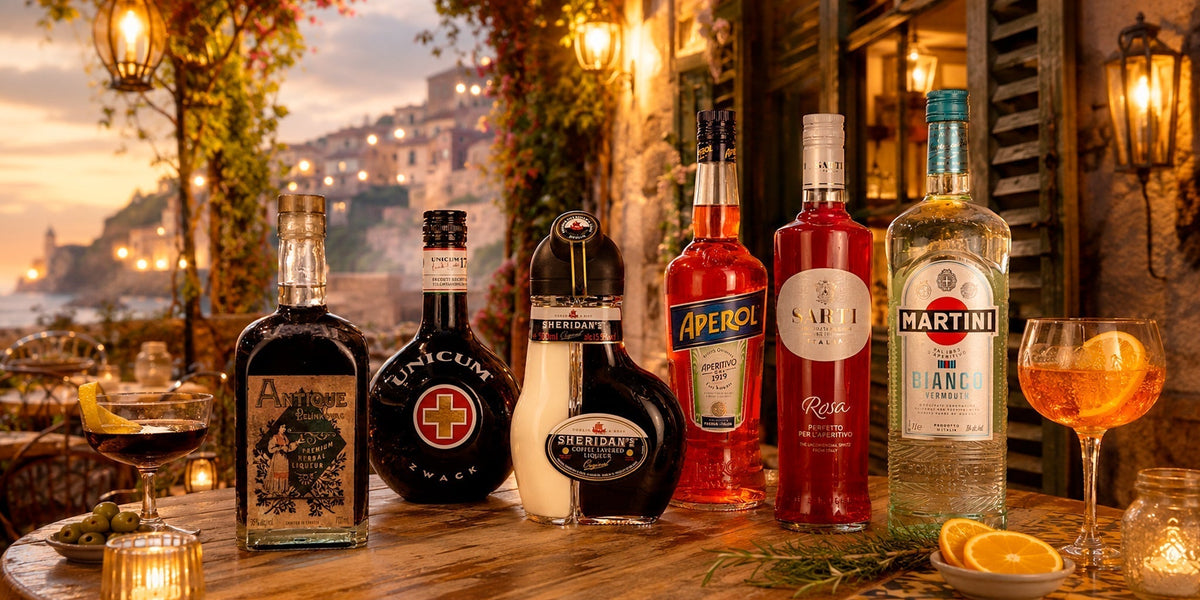 Dinner party drinks selection with Antique Pelinkovac, Zwack Unicum, Sheridan’s, Aperol, Sarti Rosa and Martini Bianco on a warm coastal restaurant table.