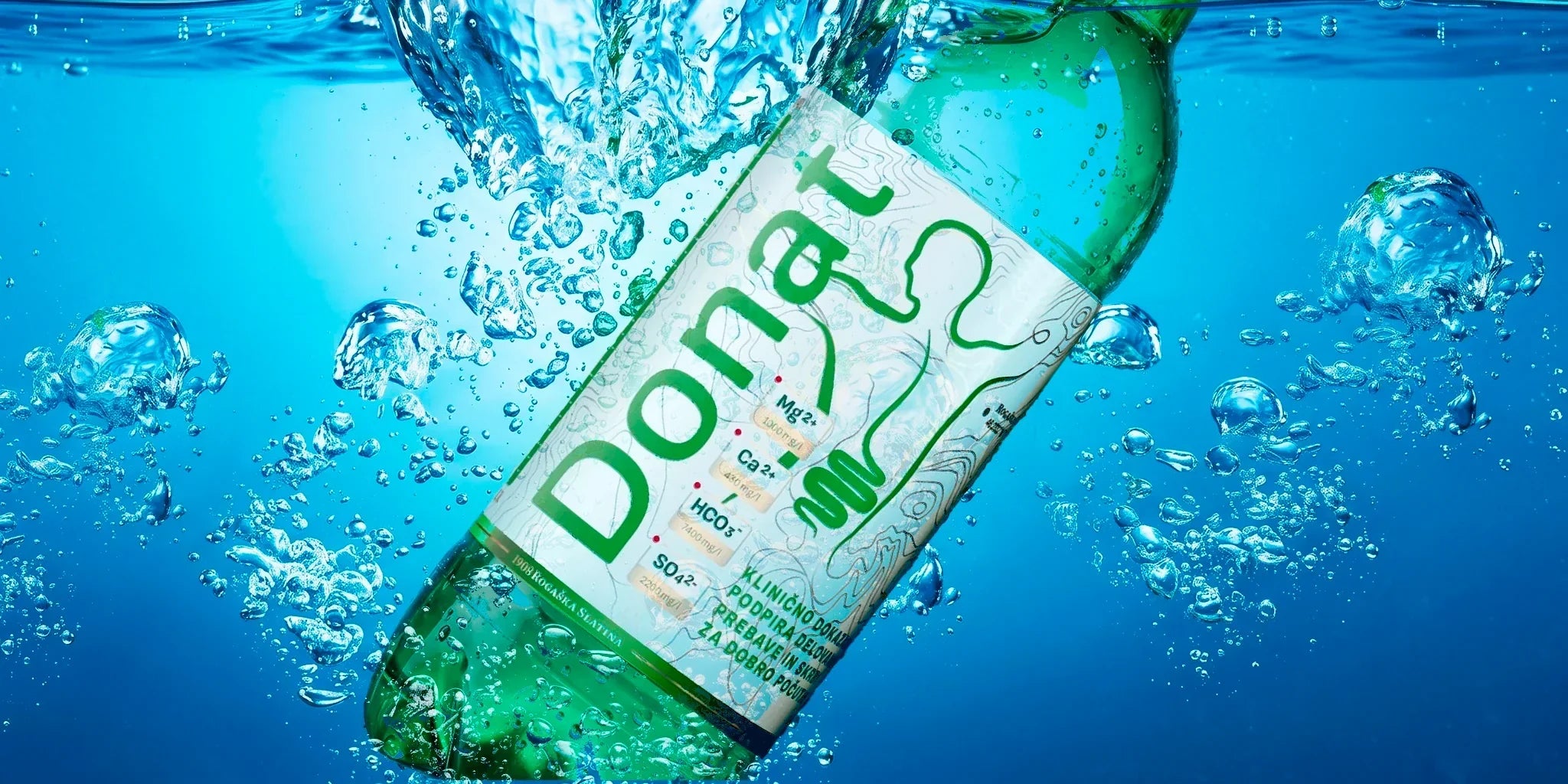 Donat mineral water bottle underwater with fresh blue bubbles, styled as a clean refreshing wellness drink image for natural hydration and daily mineral balance.