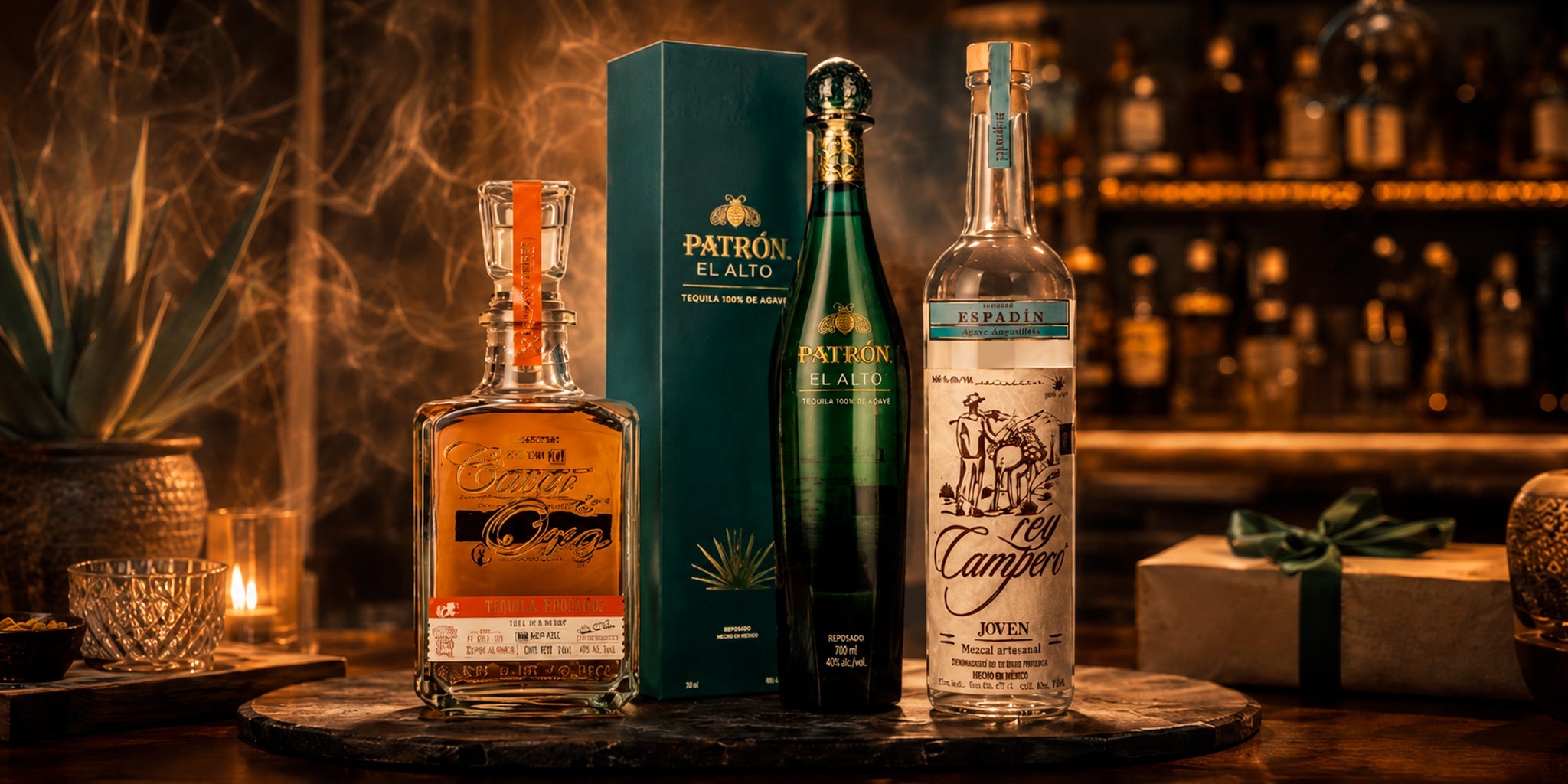 Premium agave spirits with tequila and mezcal bottles on a dark bar tray, styled with agave, smoke, warm lighting and gift-ready cocktail bar atmosphere.